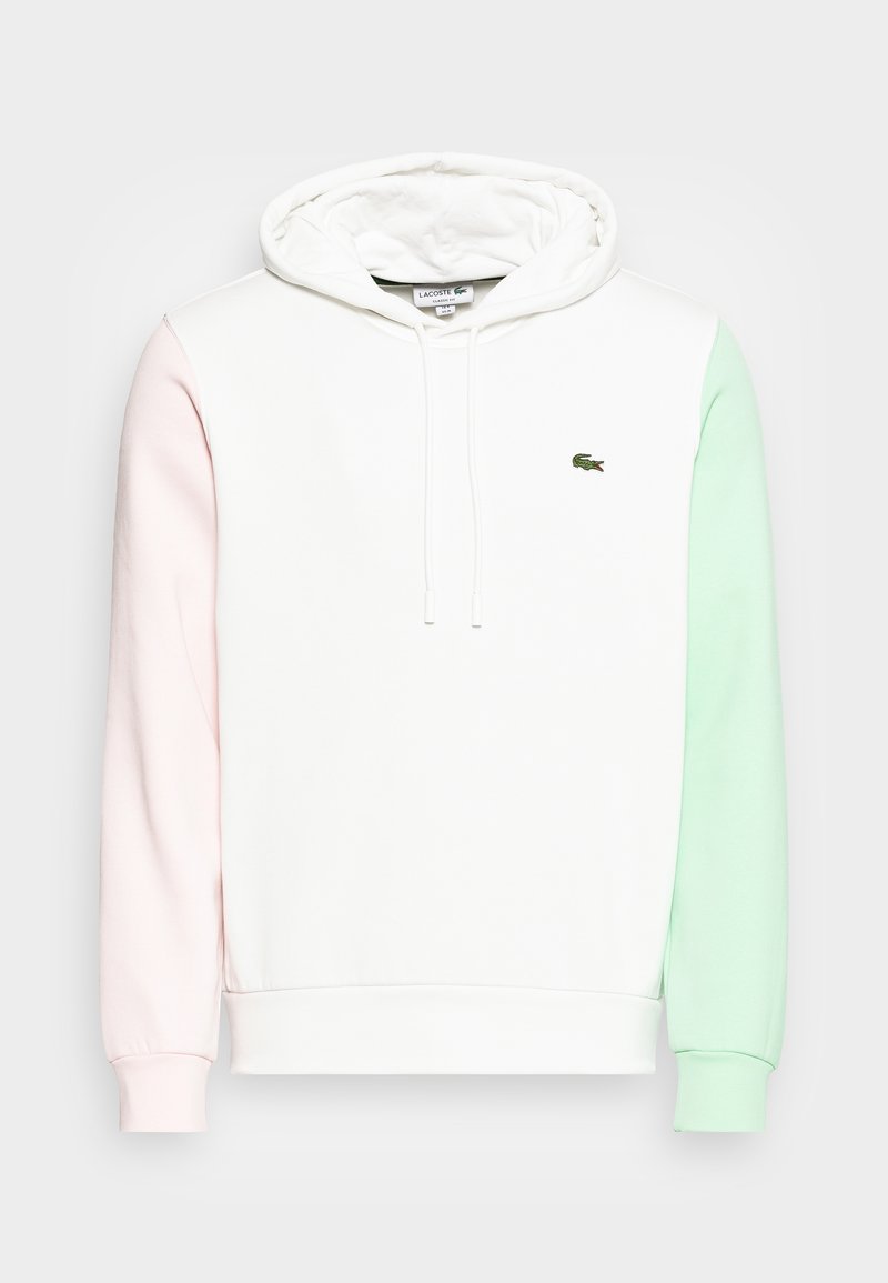 Felpa con cappuccio in bianco, rosa e verde menta. Presenta lacci, polsini a costine e un piccolo logo Lacoste sul petto. Tessuto morbido.