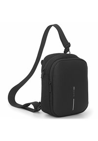 Black synthetic shoulder bag with a rectangular shape, front zipper pocket, adjustable strap, and a reflective line on the front.