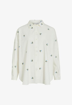 Hvit langermet skjorte med knapper foran, med små blå blomster og grønne bladmønstre spredt over stoffet.