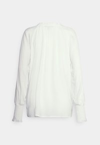 Blusa branca de manga longa com decote franzido, punhos com elástico e uma textura leve e fluida. Sem padrões ou gráficos visíveis.