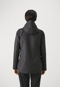 Black waterproof jacket with a hood, featuring a smooth texture and a slightly longer back hem for coverage. Simple design with no visible logos.