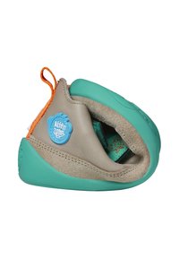 Soft, flexible beige and turquoise toddler shoe with orange pull tab and blue logo patch, shown bent to highlight its foldability.