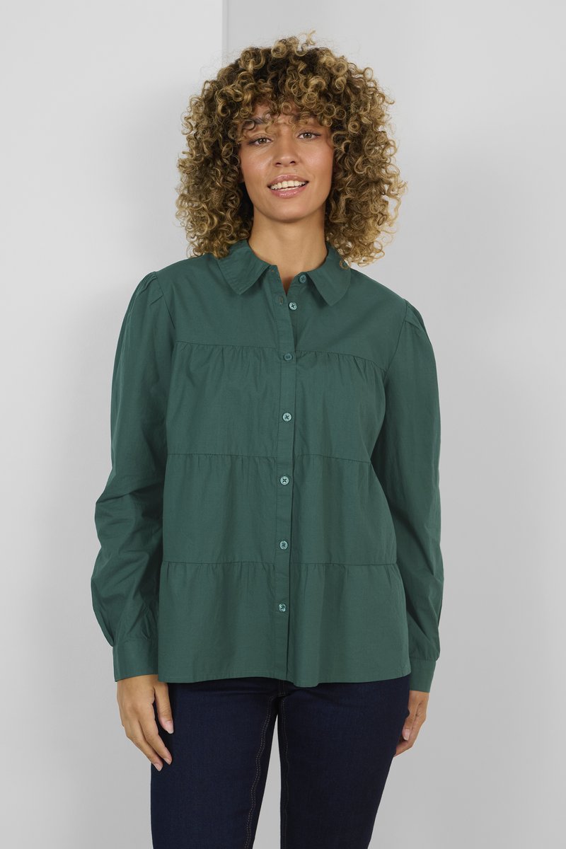 Green, button-up shirt featuring a tiered design, long sleeves, and a pointed collar. Made of smooth fabric with a slight sheen.