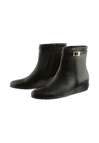 Black leather ankle boots feature a side zipper, rounded toe, and a small gold buckle accent on the outer side. Flat rubber sole.