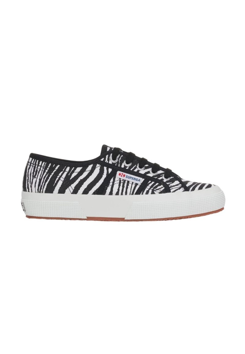 Sneaker in tela a strisce zebra bianco e nero con suola in gomma, caratterizzato da lacci neri e una suola intermedia bianca con dettagli testurizzati.