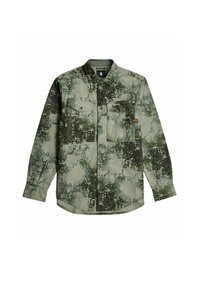 Kortärmad skjorta med knäppning i ett grönt pixelerat kamouflage-mönster. Har två bröstfickor och en rundad nederkant. Tillverkad av bomull.