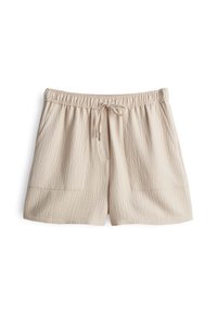 Shorts en tissu texturé beige clair avec taille élastique, lien de serrage et poches plaquées à l'avant.