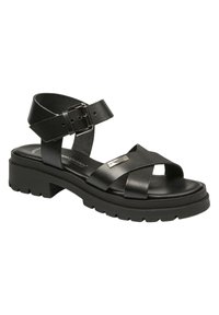 Sandalias de cuero negro con diseño de tiras cruzadas, correa de tobillo ajustable con hebilla, y suela de goma gruesa con dibujo texturizado para mayor agarre.