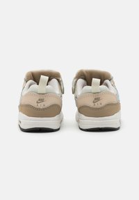Brązowe i beżowe sneakersy wykonane z siateczki i skóry. Posiadają niebieskie akcenty, logo na pięcie oraz pętelkę z tyłu.