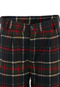 Pantalon à carreaux avec des motifs noirs, rouges et beiges. Confectionné dans un tissu texturé, avec une fermeture à bouton et des poches latérales.