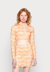 Vestido laranja de manga longa com uma cintura recortada, apresentando um padrão texturizado e um tecido suave, concebido para uma silhueta justa.