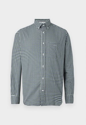 Men’s long-sleeve button-up shirt with navy blue and white checkered pattern and a chest pocket on a white background.