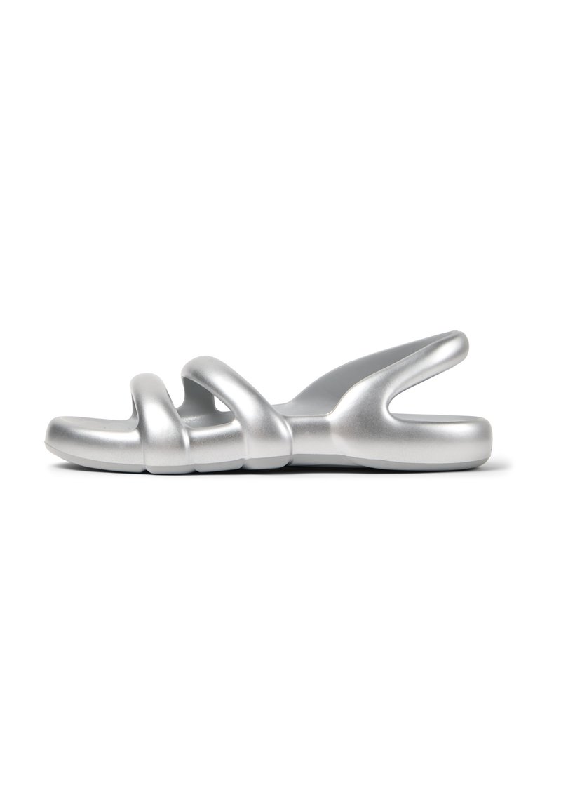 Silver slide sandal with a smooth, matte finish. Features three looping straps and a contoured sole for comfort. Minimalist design.