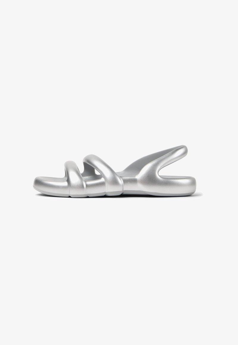 Silver slide sandal with a smooth, matte finish. Features three looping straps and a contoured sole for comfort. Minimalist design.