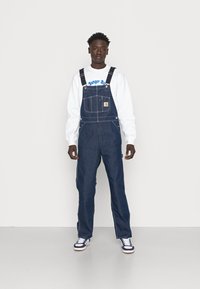 Carhartt WIP BIB OVERALL - Laisvo kirpimo džinsai - blue one wash