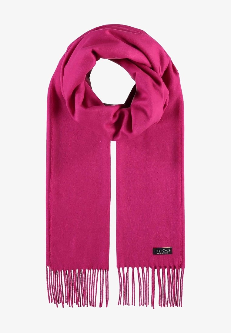 Écharpe en laine rose vif avec des extrémités à franges et une petite étiquette de marque noire près d'un bord.