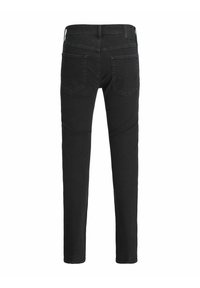 Black denim jeans with a slim fit, featuring a mid-rise waistband, back pockets, and subtle stitching details. Smooth texture and minimal design.