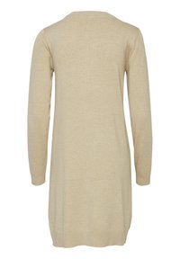 Tunique en tricot beige avec des manches longues, un col rond et une texture lisse. L'ourlet atteint le milieu de la cuisse avec des poignets de manche côtelés.