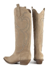 Beige suede knee-high boots with a pointed toe, featuring silver-tone studs in a swirling pattern along the shaft. Stacked wooden heel.