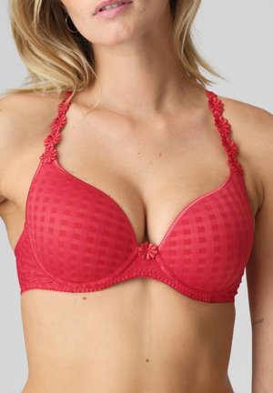 Reggiseno rosso con texture a quadri, spalline in pizzo regolabili con decorazioni floreali e un fiocco decorativo al centro. Finitura liscia e supporto con ferretto.