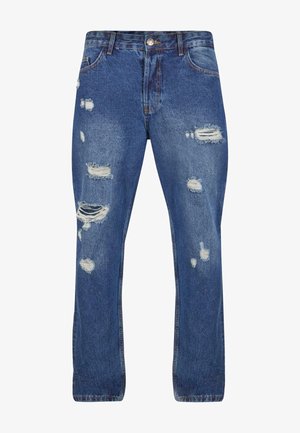 Kék farmernadrág, laza szabással, több eldartolt résszel és rojtos részletekkel, klasszikus öt zsebes dizájnnal és gombos zárással.