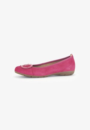 Pink suede ballet flat with a round toe and prominent decorative button on the vamp. Flexible rubber sole with a slight heel. Soft texture.