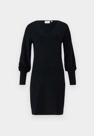 Black knit dress with V-neckline and long puffed sleeves ending in fitted ribbed cuffs.