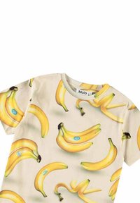 Kortærmet beige t-shirt med forskellige gule banangrafikker og et blåt mærke. Glat stof med rund halsudskæring og ingen synlige detaljer.