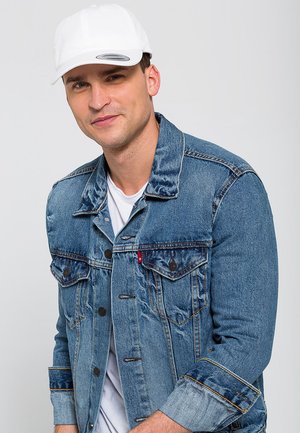 Jachetă din denim de culoare albastru deschis, cu un croi clasic, având două buzunare pe piept și cusături în contrast. Purtați-o peste un tricou alb și o șapcă albă.