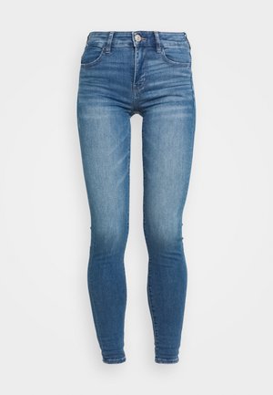 Skinny jeans in lichtblauwe denim met een vervaagde wassing, knoopsluiting, riemlussen en twee voorzakken, met een soepele textuur.