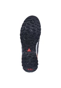 Black rubber outsole featuring a textured, multidirectional tread pattern. Notable red triangular accent and branding detail in red.