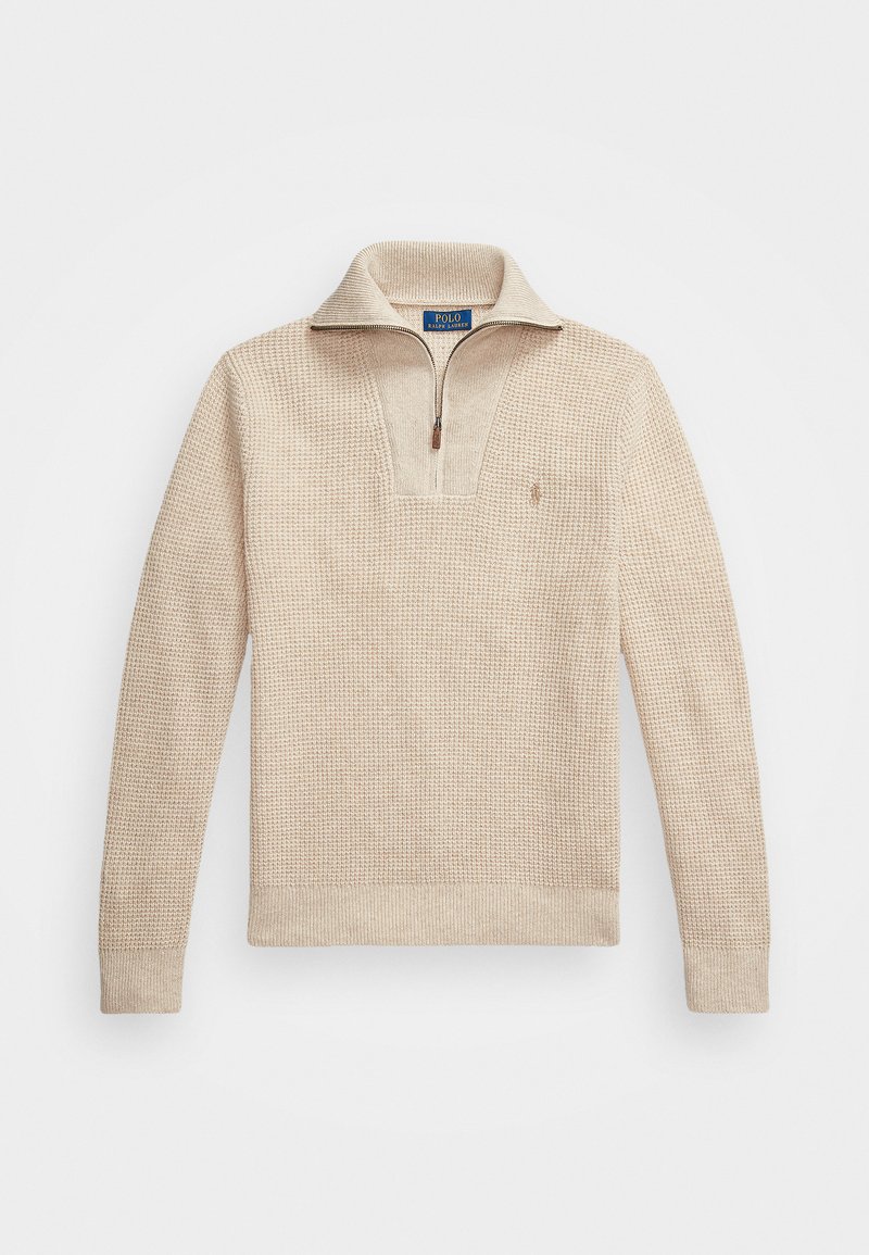 Beige, teksturert genser med glidelås i kragen. Har ribbestrikkede mansjetter og nederkant, og en liten brodert logo på brystet.
