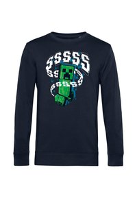 Sudadera de manga larga azul marino con un gráfico de un personaje pixelado en verde rodeado de signos de dólar en acentos blancos y azules.