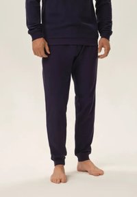 Granatowe dresy wykonane z miękkiego materiału, z elastycznym pasem i mankietami przy kostkach dla komfortowego dopasowania.