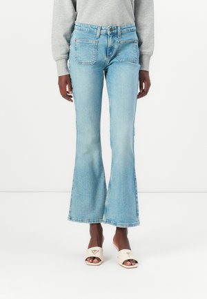 Light blue flared jeans made from denim, featuring a high waist, two back pockets, and a raw hem at the bottom.