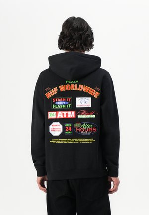 Black hooded sweatshirt featuring colorful graphics on the back, including logos and text for "HUF WORLDWIDE" and other signage elements.