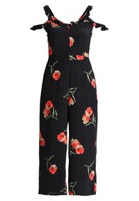 Czarny kombinezon w kwiaty z czerwonymi kwiatami, zielonymi łodygami i białymi kropkami. Posiada odkryte ramiona i szerokie nogawki. Lekki materiał.