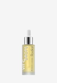Klares Glas-Tropferfläschchen mit einem silbernen Deckel; enthält ein leicht gelbes Serum, das mit "Vit C Drops Rodial" beschriftet ist, in einem matten weißen Textdesign.