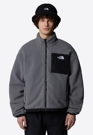 Gray fleece jacket with a black pocket, full zipper, high collar, and elastic cuffs. Accompanied by a matching black bucket hat.