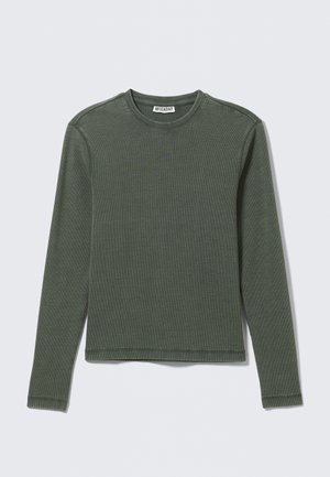 Long-sleeve, ribbed top in dark green, featuring a crew neckline and straight hem. Made of soft fabric, with minimal seams and no visible patterns.