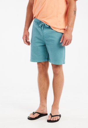 Shorts de bain turquoise en matière mélangée coton, dotés d'une taille élastique avec cordon de serrage et de poches latérales.