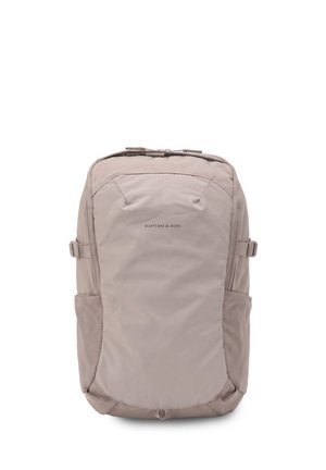 Beige Kapten & Son backpack with front zip pocket, side straps, and two side mesh pockets, shown from front on a white background.