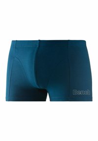 Men's boxer briefs in dark teal fabric, featuring a fitted design, soft texture, and a white "Bench" logo on the lower right side.
