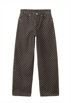 Czarne spodnie z wysokim stanem w białe kropki, zapinane z przodu na guziki i zamek błyskawiczny, z pięcioma kieszeniami.