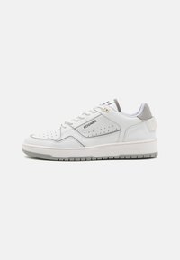 White leather sneaker with perforated sides, grey accents, and flat rubber sole. Features laces and brand logo on the side and heel.