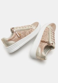 Sneakers rosa e oro con una finitura testurizzata, motivi floreali perforati, zip argento e suole in gomma bianca.