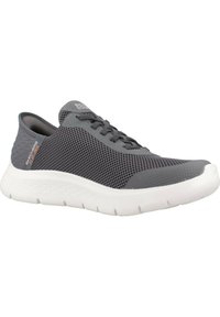 Gray athletic shoe with a mesh fabric upper, white sole, rounded toe, and gray laces. Features a textured surface and brand logo on side.