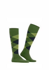 Kniestrümpfe in grün mit einem Rautenmuster in dunkelgrün und marineblau. Hergestellt aus glattem Stoff, mit einem gerippten Bündchen für einen sicheren Sitz.