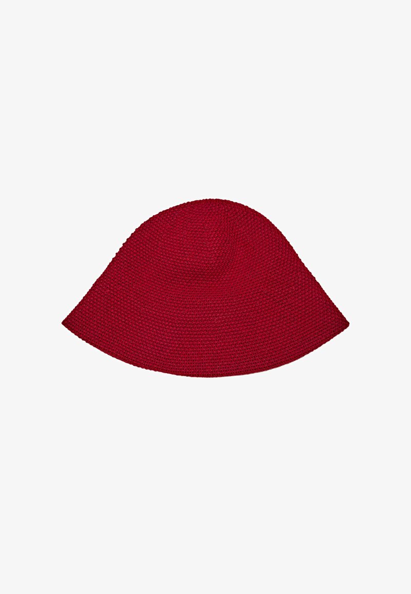 Red woven hat with a floppy design, rounded top, and wide brim. Made from textured material, showcasing a seamless and smooth finish.