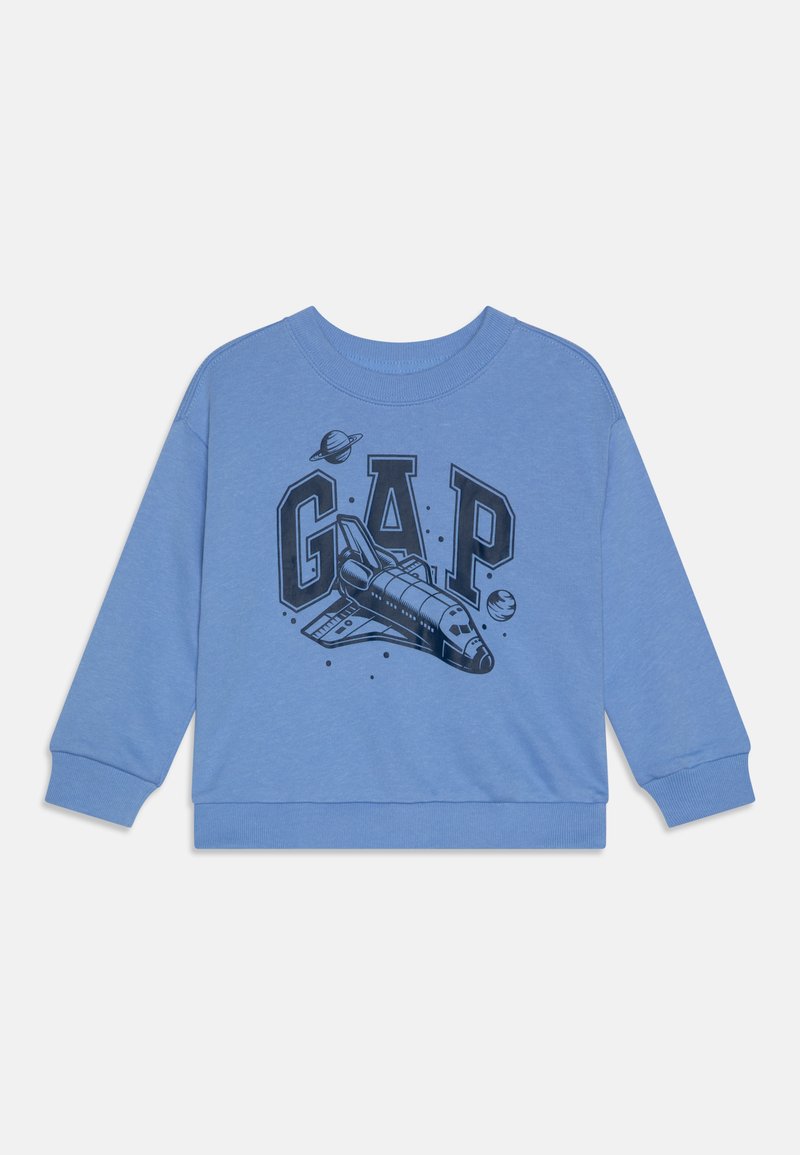 Modrá mikina s černou grafikou raketoplánu a slovem "GAP" spolu s planetami, vyrobená z měkké tkaniny s žebrovanými manžetami.